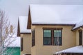 Upper storey of home with snowy roof in winter