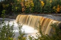 Upper Tahquamenon Falls closeup waterfall photo in Upper Michigan with water cascading into the river below surrounded by Royalty Free Stock Photo