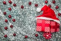 Upper, top, view from above of, evergreen red toys, Christmas presents and Santa hat on gray marble background Royalty Free Stock Photo