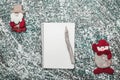 Upper, top, view from above of a notepad, wooden vintage pen, and handmade Santa and snowman toys Royalty Free Stock Photo