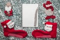 Upper, top, view from above of a notepad, wooden vintage pen, handmade snowman toy and Santa socks on gray marble background Royalty Free Stock Photo