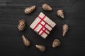 Upper, top view, of Christmas presents on a wooden black rustic background, suround. Royalty Free Stock Photo