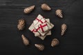 Upper, top view, of Christmas presents on a wooden black rustic background, suround. Royalty Free Stock Photo