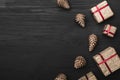 Upper, top view, of Christmas presents on a wooden black rustic background. Royalty Free Stock Photo