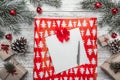 Upper, top view, of Christmas presents on a wooden rustic background, decorated with evergreen branch, pins, toys. Royalty Free Stock Photo