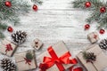 Upper, top view, of Christmas presents on a wooden rustic background, decorated with evergreen branch. Royalty Free Stock Photo