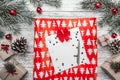 Upper, top view, of Christmas presents on a wooden rustic background, decorated with evergreen branch, pins, toys, stars. Royalty Free Stock Photo