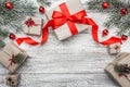 Upper, top view, of Christmas presents on a wooden rustic background, decorated with evergreen branch and toys. Royalty Free Stock Photo