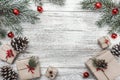 Upper, top view, of Christmas presents on a wooden rustic background, decorated with evergreen branch. Royalty Free Stock Photo