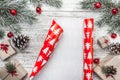 Upper, top view, of Christmas presents on a wooden rustic background, decorated with evergreen branch.