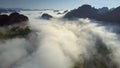 Upper view boundless hills protrude through clouds