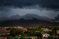 upper view of city dark thunderclouds above city mountains