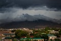 upper view of city dark thunderclouds above city mountains