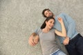 Upper view of couple lying on carpet floor