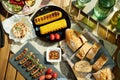 Upper view of desk with electric grill, grilled sausages and cor Royalty Free Stock Photo