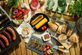 Upper view of desk with electric grill and grilled sausages Royalty Free Stock Photo