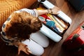 Furious modern woman closing over packed suitcase