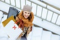 Upper view of happy elegant woman in brown hat and scarf