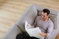 Man in sofa reading news Royalty Free Stock Photo