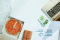 Upper view of pizza at table with documents and laptop Royalty Free Stock Photo