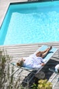 Upper view of senior woman relaxing by pool Royalty Free Stock Photo