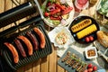 Upper view of table with electric grill and grilled sausages Royalty Free Stock Photo