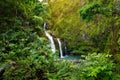 Upper Waikani Falls also known as Three Bears, a trio of large waterfalls amid rocks & lush vegetation with a popular swimming hol