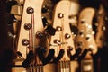Uppermost part of the guitar. Close view of several acoustic guitar headstocks with tuning keys for adjusting guitar