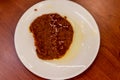 A upperview shoot to red sauce with spicy pepper with plate