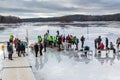 Group of ice skaters and volunteers at a rest area on the ice. Royalty Free Stock Photo