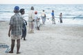 Uppuveli, Sri Lanka - March 26 2017: Local fishermen pulling at the rope of the fishernet at the beach Royalty Free Stock Photo