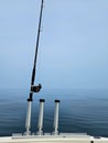Upright Fishing Rod Holders on Boat with Pole and Lake Water Royalty Free Stock Photo