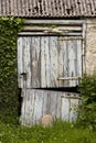 A dilapidated wooden barn door