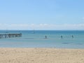 Upright paddle boarders in a calm sea