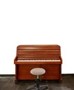 Upright piano and a stool isolated on white Royalty Free Stock Photo