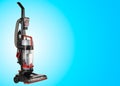 Upright Vacuum Cleaner on blue Background. House Cleaning Equipment Tool.