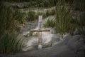 Wooden cross amongst sand dunes Royalty Free Stock Photo