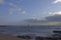 The upright wooden Rock Markers of Westhaven Beach at Low tide