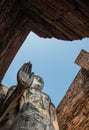 Uprisen angle view of old stand buddha statue in the ancient temple Thailand