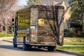 UPS panel truck dusty and dirty at back parked at curb in residential area in springtime