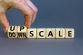 Upscale or downscale symbol. Concept words Upscale or Downscale on wooden cubes. Beautiful grey table grey background. Businessman