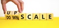 Upscale or downscale symbol. Concept words Upscale or Downscale on wooden cubes. Beautiful yellow table white background.