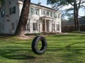 Upscale home with shaded front yard and swing Royalty Free Stock Photo