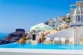 Upscale hotels with pool and churches on cliff edge Fira Santorini Greece Royalty Free Stock Photo