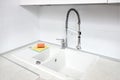 Upscale kitchen Ultimate Gray interior with Illuminating yellow sponge for washing dishes. Faucet mixer and stone sink Royalty Free Stock Photo