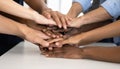 A close-up photograph captures a diverse group of people stack their hands one atop another. Generated image Royalty Free Stock Photo
