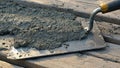 Fresh Wet Concrete Mixture On Trowel Over Wooden Planks During Early Construction Stage Of Building Project Outdoors Royalty Free Stock Photo