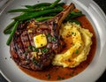 delicious plate featuring a juicy steak, creamy mashed potatoes, and fresh green beans, garnished with butter and herbs. Royalty Free Stock Photo
