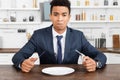 Upset african american man holding cutlery Royalty Free Stock Photo