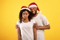 Upset african american woman and boyfriend comforting her on yellow studio background, copy space Royalty Free Stock Photo